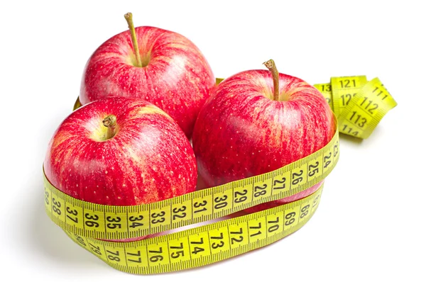 Red apples and measuring tape — Stock Photo, Image