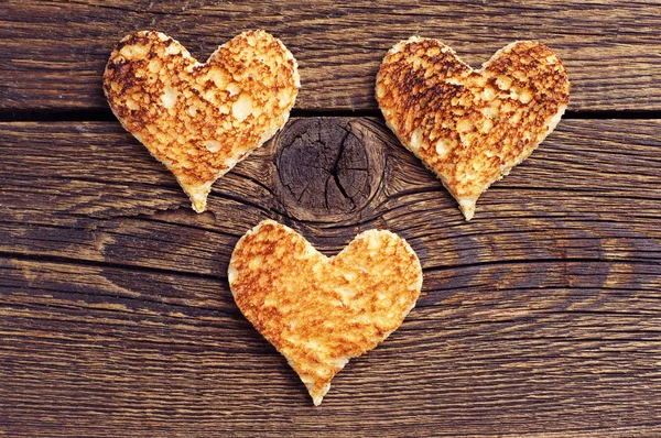 Three toast bread in the shape of hearts — Stock Photo, Image