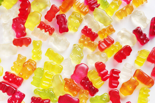 Background of gummy bear candies on white