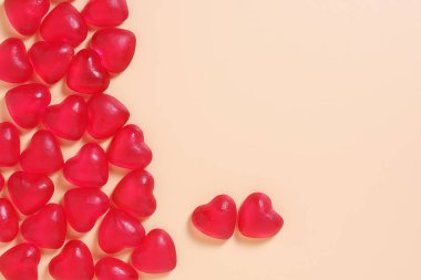 Sarı arka planda kalp şeklinde jöle şekerler. Üst görünüm, alanı kopyala 