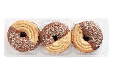 Cookies with coconut and milk chocolate packaged in a transparent plastic container isolated on a white background, top view