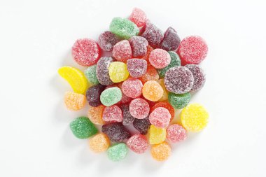 Fruit flavored jelly candies on white background close up, top view