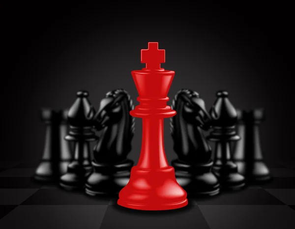 Red King stand out against black chess pieces — Stock Photo, Image