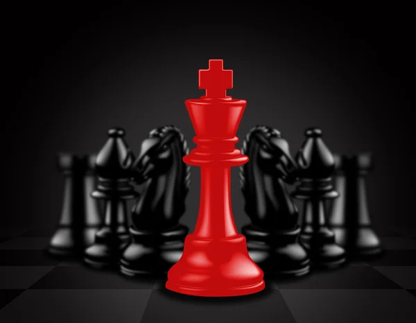 Červený král vystupovat proti černým šachové figurky — Stock fotografie