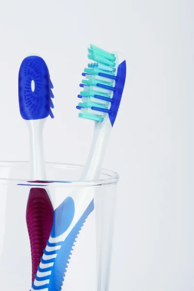 Two tooth brush in a transparent container — Stock Photo, Image