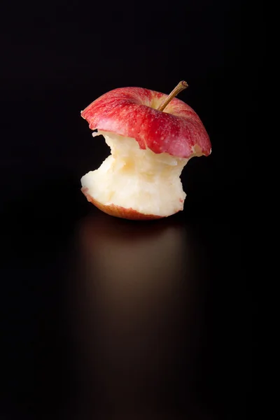 Apple core on a black background