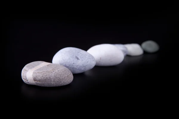 Horizontal row of stones on a black background