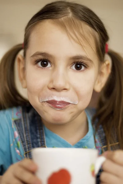 Little girl with milk mustache — Stock Photo, Image