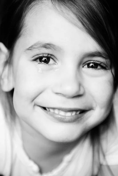 Little girl smiling and crying — Stock Photo, Image