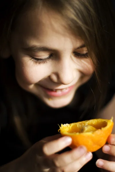 Little girl with fresh orange — Stock Photo, Image