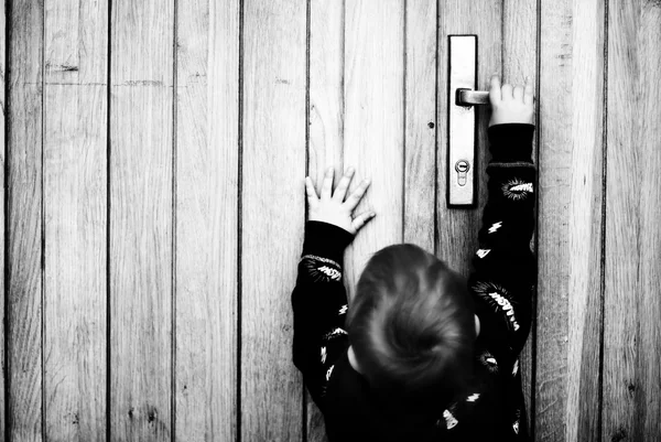 Little boy try to open the door — Stock Photo, Image