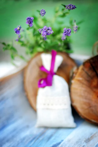 Lavender bag and some fresh lavender flowers on at wooden box — Stock Photo, Image
