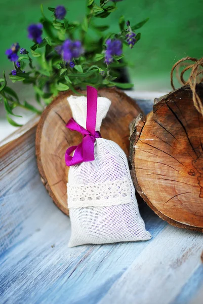 Lavender bag and some fresh lavender flowers on at wooden box — Stock Photo, Image