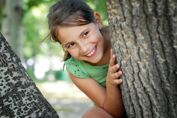 Girl sitting on the tree — Stock Photo, Image