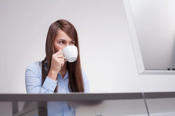 Beautiful woman with cup at work — Stock Photo, Image