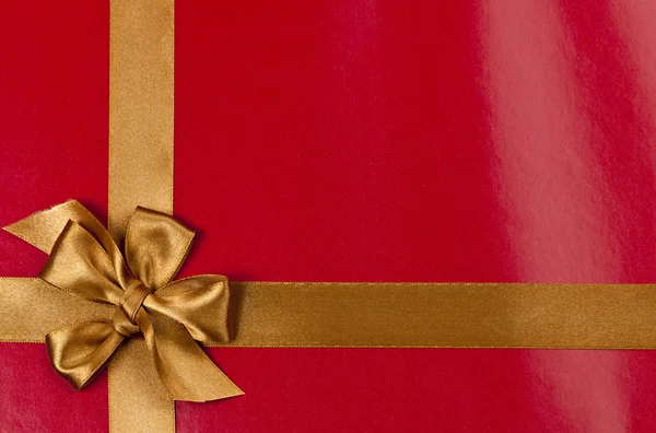 Red gift background with gold ribbon — Stock Photo, Image