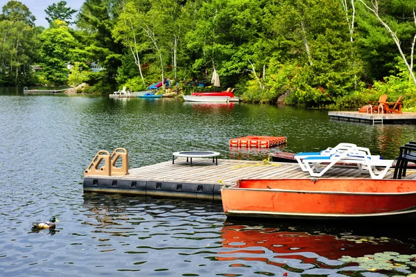 Cottage lake with diving platform and docks — Stock Photo, Image