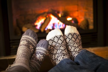 Feet warming by fireplace clipart