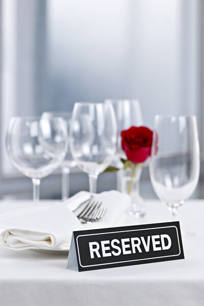 Romantic dinner setting with reserved sign