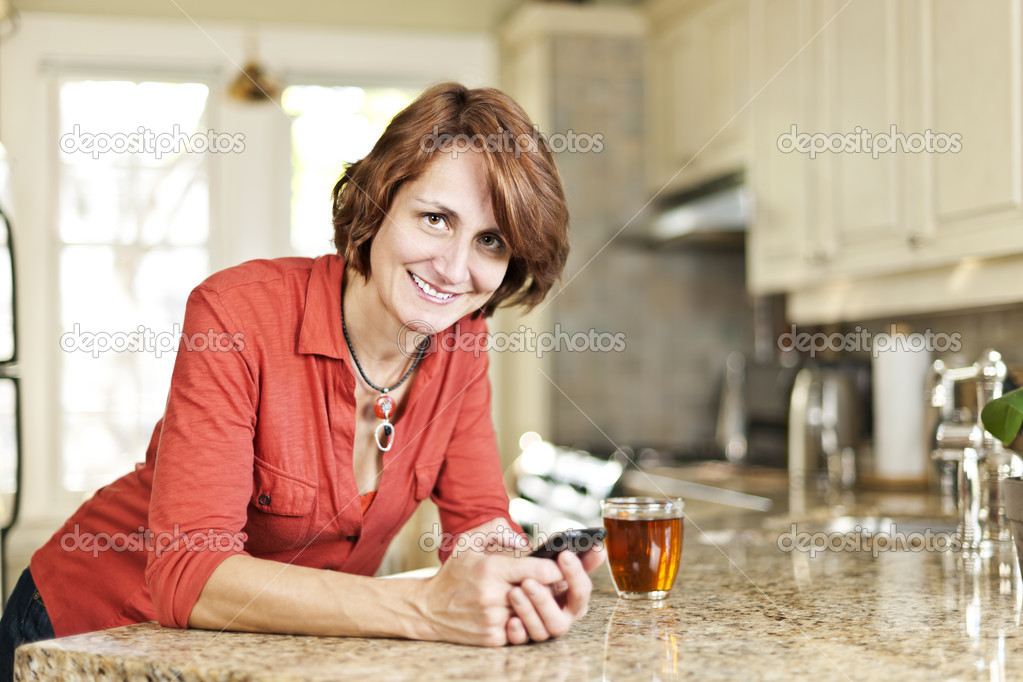 Woman using cell phone at home