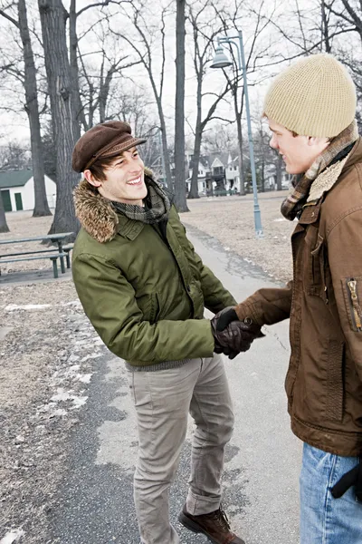 Two men shaking hands in park — Stock Photo, Image