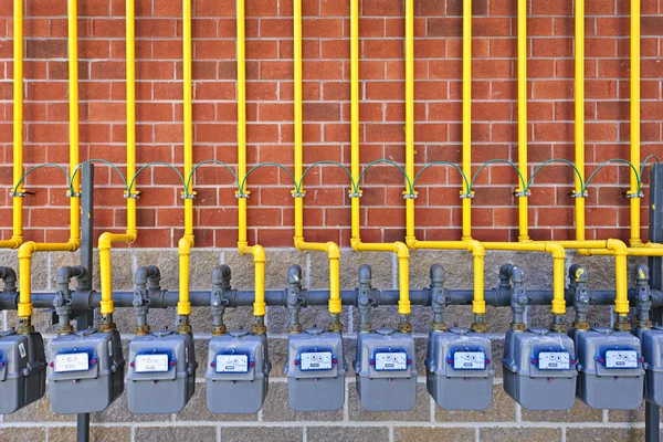 Gas meters on brick wall — Stock Photo, Image