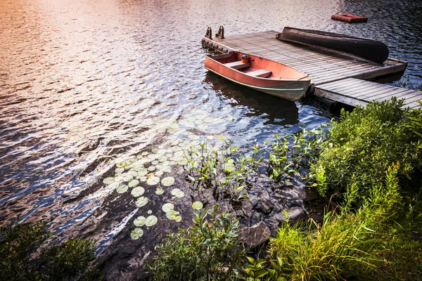 Barco de remos en la orilla del lago al amanecer — Foto de Stock