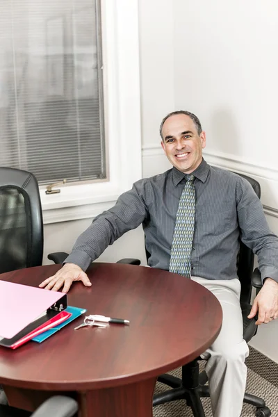 Businessman sitting in office meeting room — Stock Photo, Image