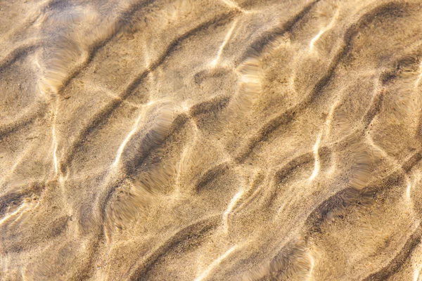 Water en zand rimpelingen — Stockfoto