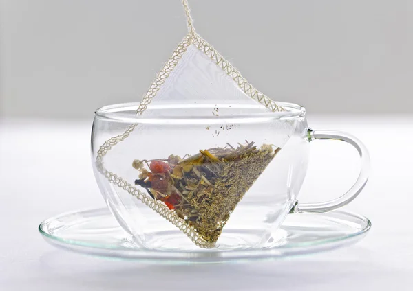 Herbal tea bag in glass cup — Stock Photo, Image