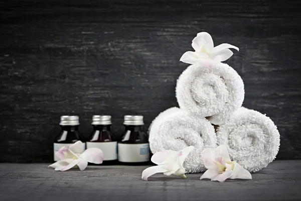 Rolled up towels and products at spa — Stock Photo, Image