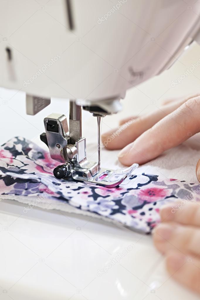 Hands with sewing machine