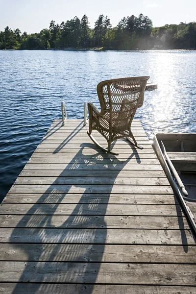 Rocking chair on small lake dock — Stock Photo, Image