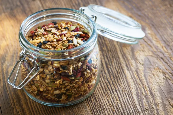 Homemade granola in open glass jar — Stock Photo, Image