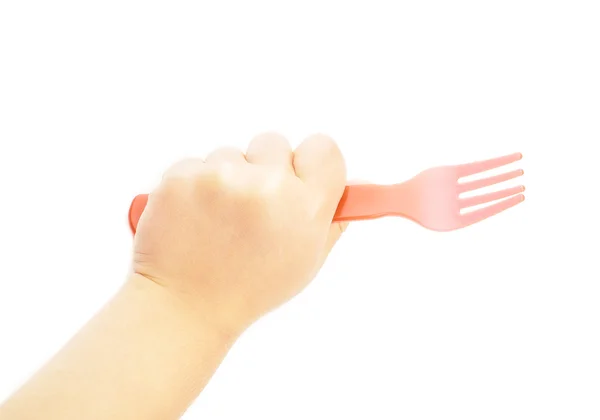 Bambino che tiene una forchetta di plastica rossa verso il bianco — Foto Stock