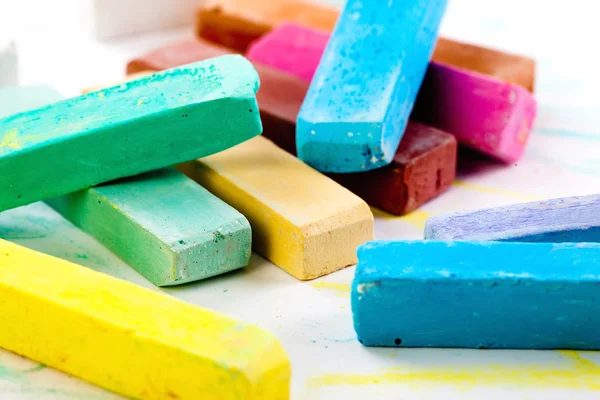 Chalks in a variety of colors arranged on a white background — Stock Photo, Image