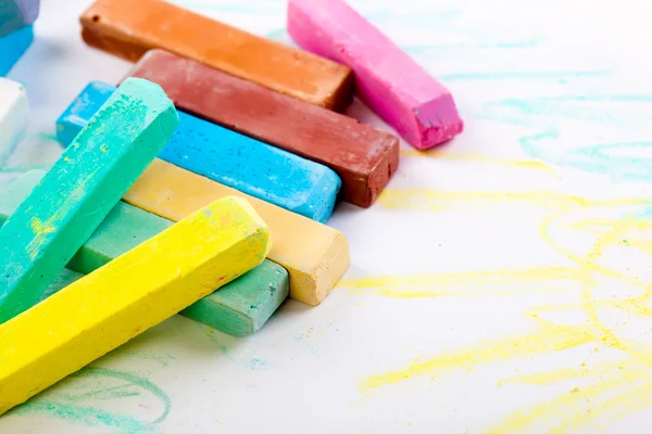 Chalks in a variety of colors arranged on a white background — Stock Photo, Image