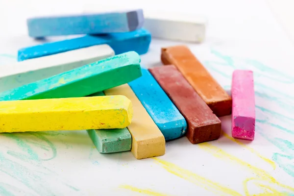 Chalks in a variety of colors arranged on a white background — Stock Photo, Image