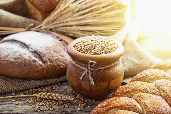 Composition of bread and spikelets on the old background — Stock Photo, Image