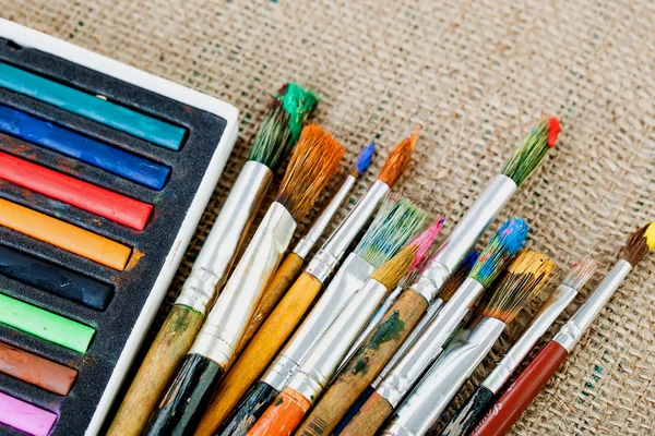 Paints and brushes in the composition — Stock Photo, Image