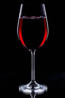 Wine in a glass on a black background