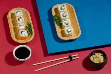 Parlak, renkli arka planda bir tabakta suşi..