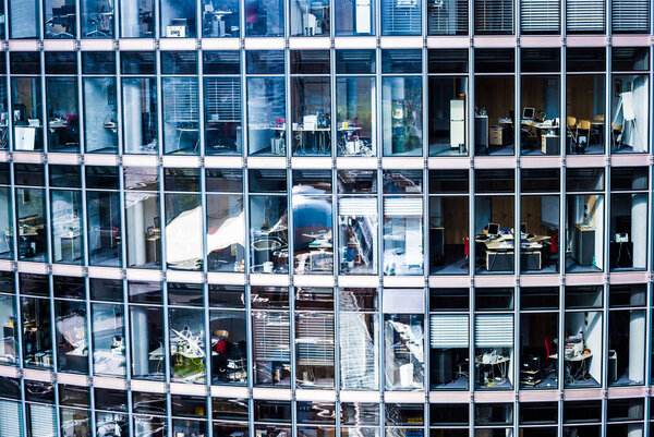 Looking inside many offices of a skyscraper