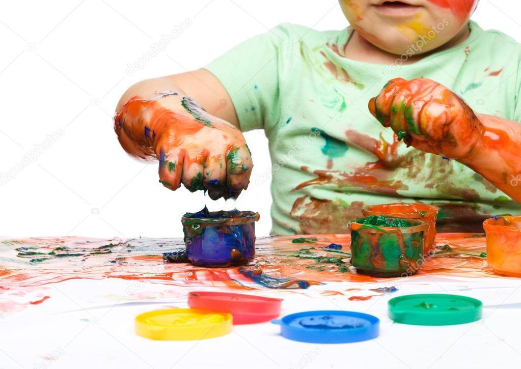 Child is grabbing some paint using fingers