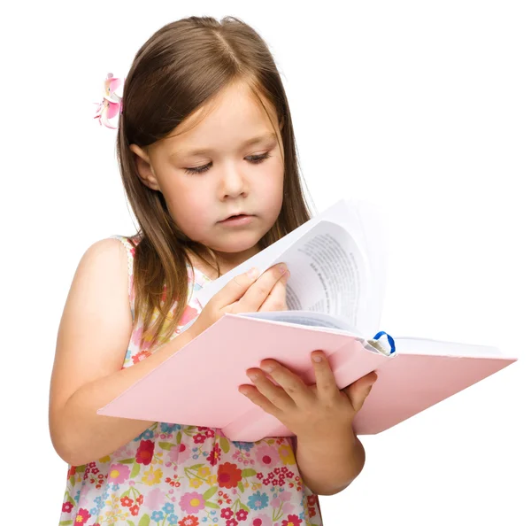 Cute little girl reads a book — Stock Photo, Image