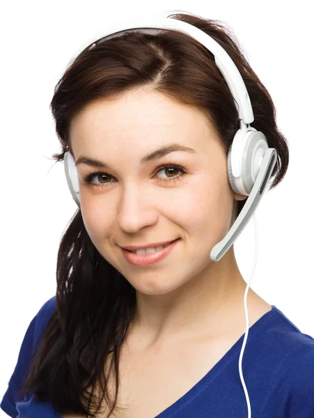 Lovely young woman is talking to customers — Stock Photo, Image