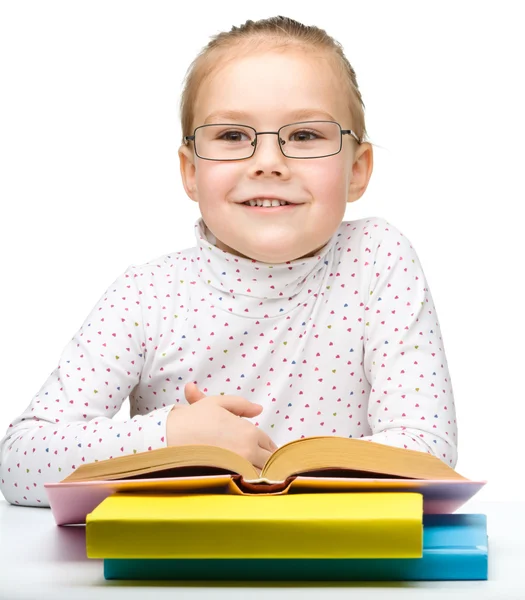 Cute cheerful little girl reading book — Stock Photo, Image