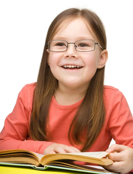 Cute cheerful little girl reading book — Stock Photo, Image