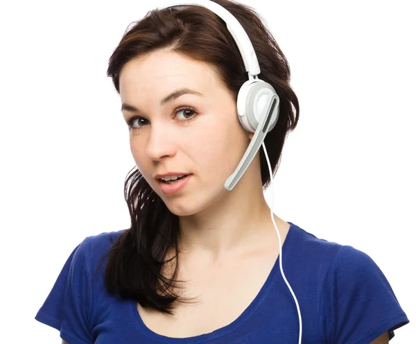 Lovely young woman is talking to customers — Stock Photo, Image