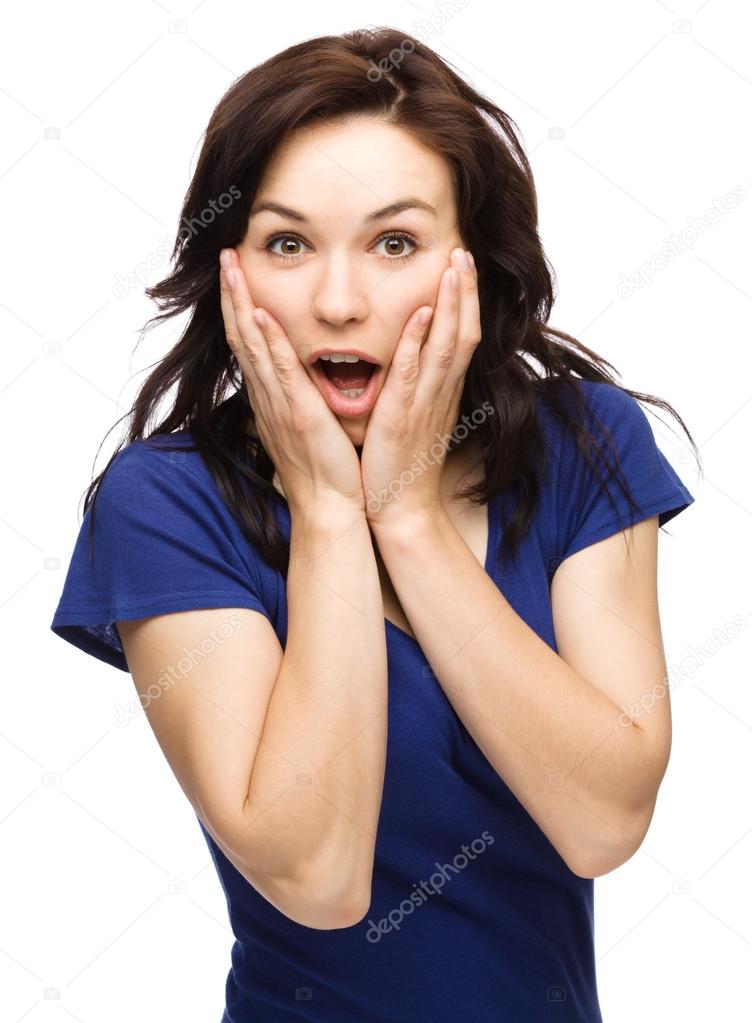 Woman is holding her face in astonishment